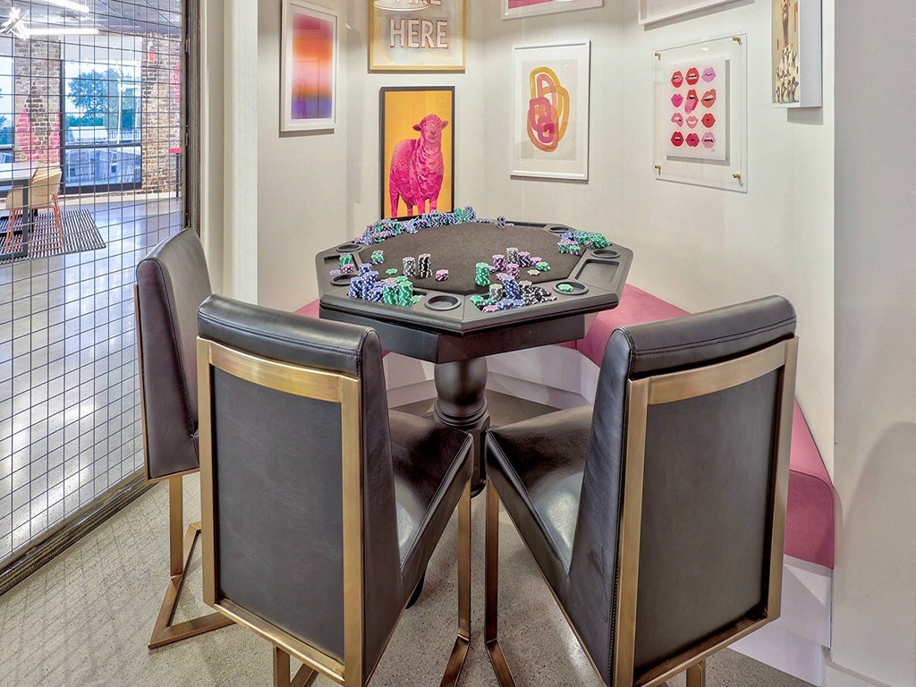 a poker table in a game room with chairs